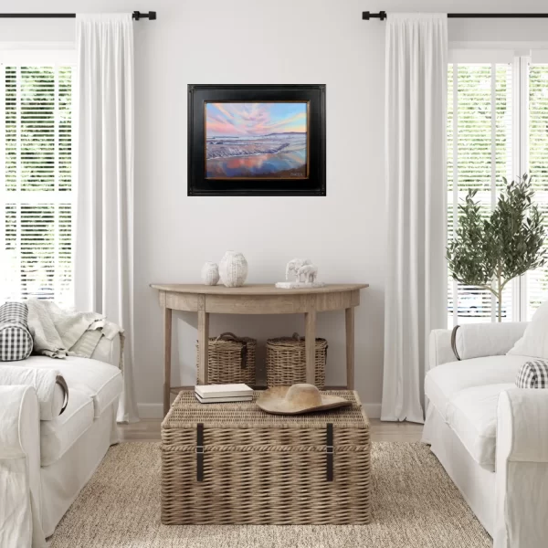 Black framed sunset seascape painting of Narragansett Beach, Rhode Island as coastal wall decor in a white living room