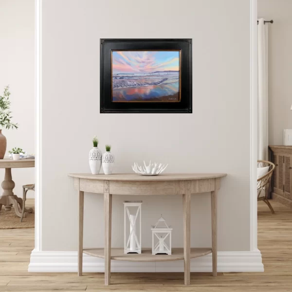 Black framed seascape painting of sunset a Narragansett Beach as coastal white hallway decor