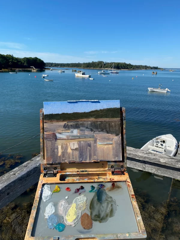 Plein air oil painting a lobster boat from the pier in Friendship Cove, Maine